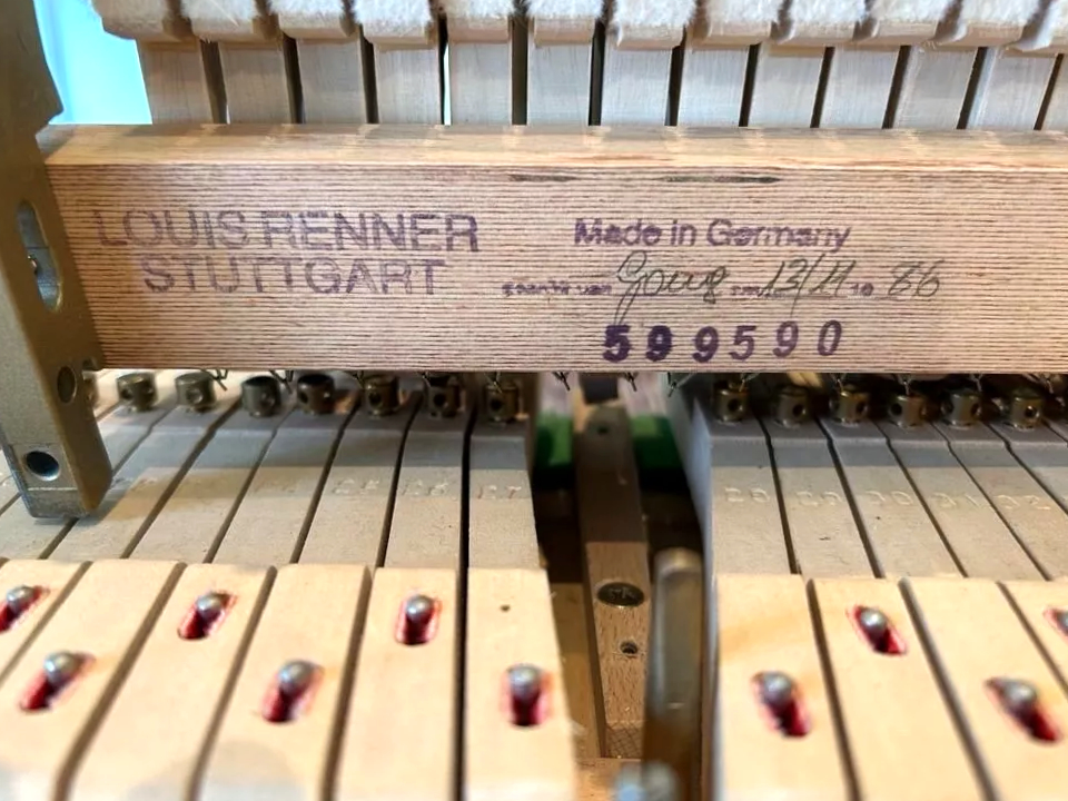 schimmel baby grand piano action detail with maker's signature